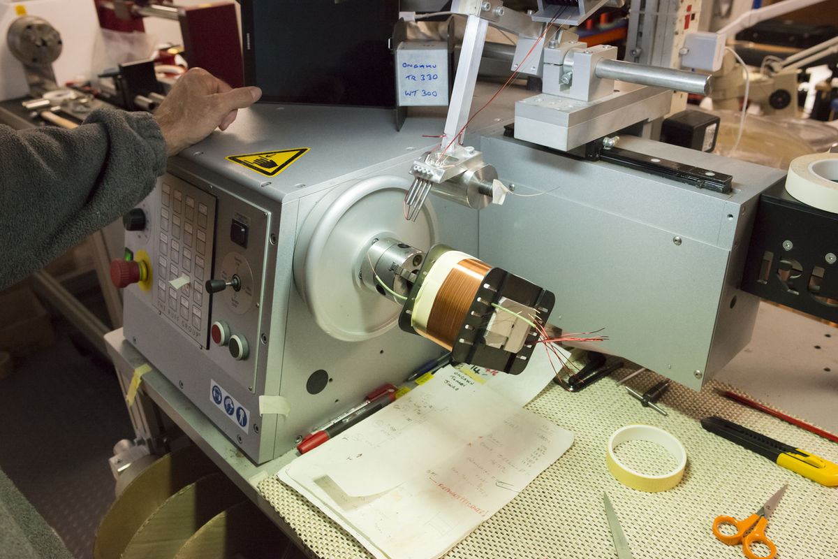 Hand-winding an Ongaku output transformer at the Brighton factory — the silver-wired transformers and hand-wound chokes that define Audio Note at the upper Levels.
