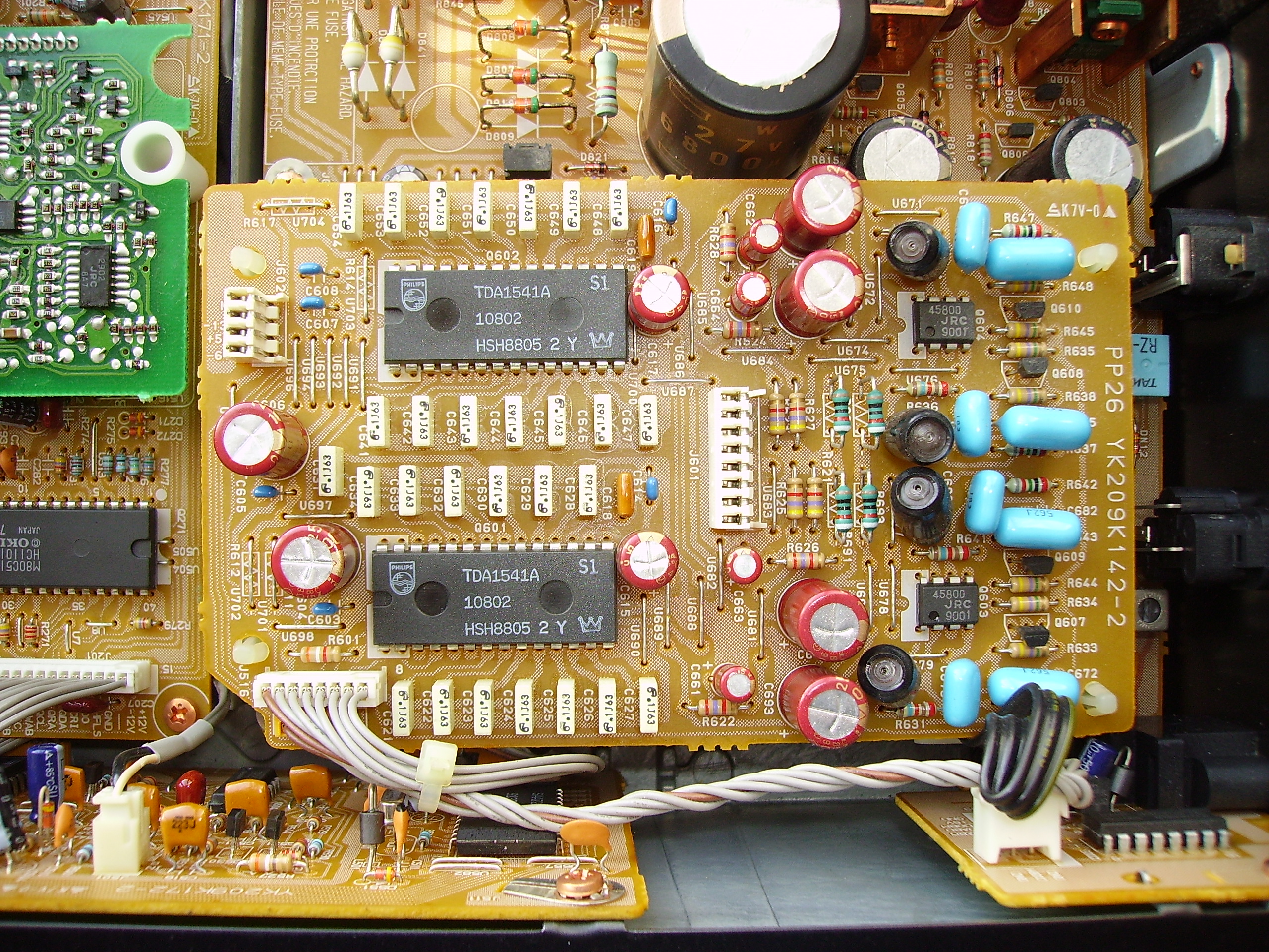 Two Philips TDA1541A S1 R2R DAC chips on a vintage CD-player board surrounded by through-hole resistors and capacitors.